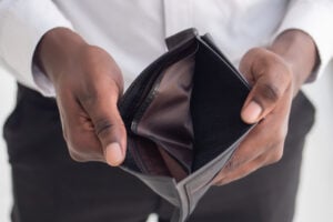 Jobless African black man have no money; concept of no money, economic recession, great depression, joblessness, unemployment, unemployed people, layoff, financial problem, financial crisis, job cut